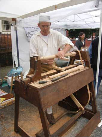 Reenactor working at a lathe